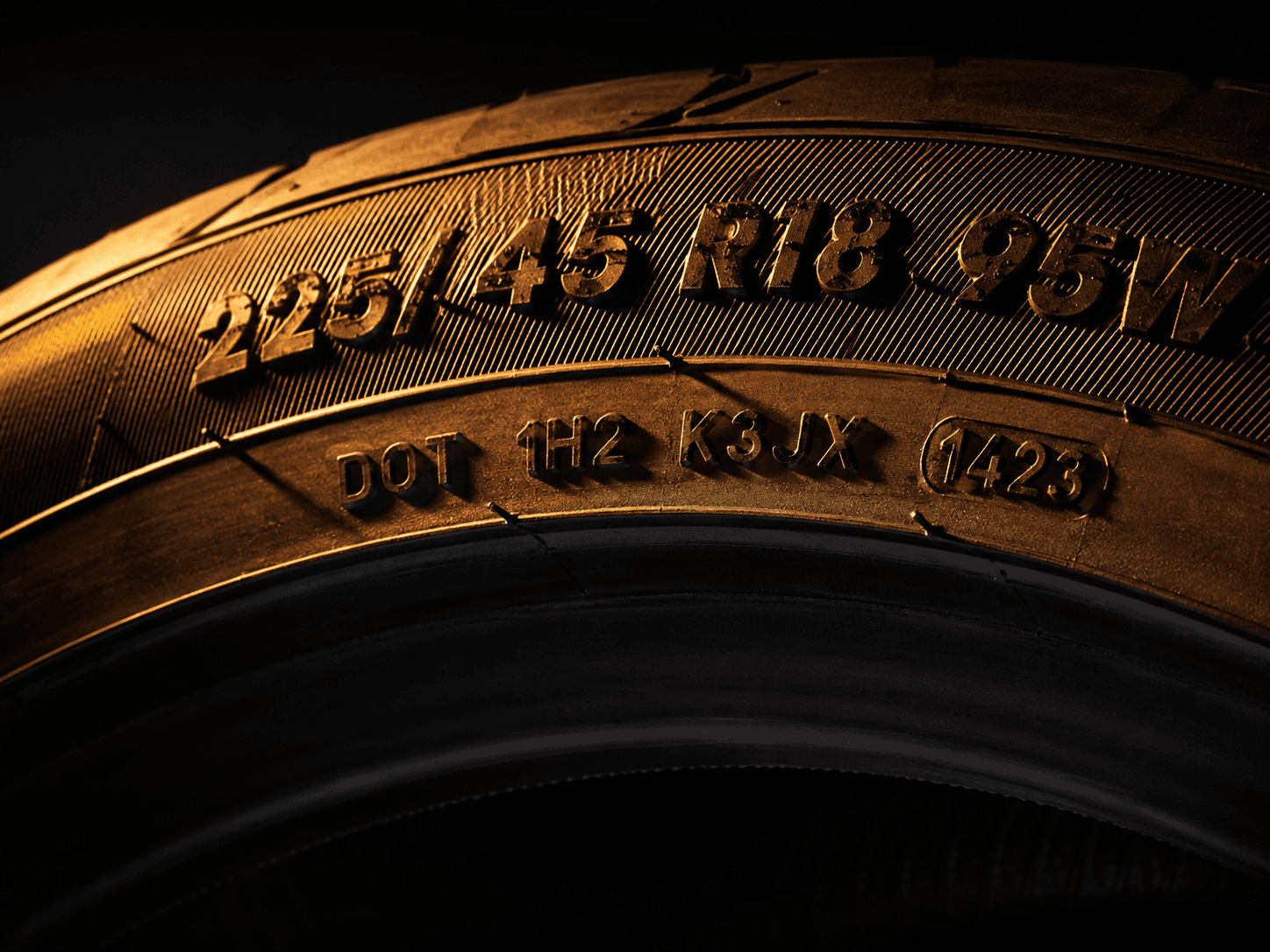 Macro photograph of a DOT code moulded into a tyre sidewall